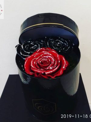 Composition with 2 wonderful forever black and red roses with silver glitter.