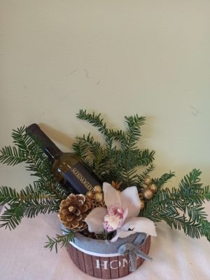 Basket with fir and orchid wine in golden shades